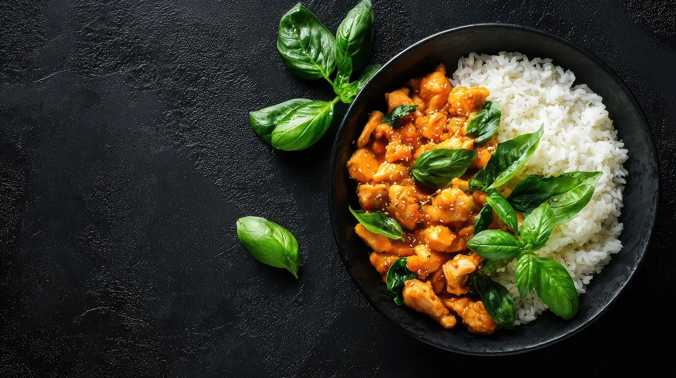 chicken curry with rice fresh basil dark background showing protein, carbs and fat for counting macros
